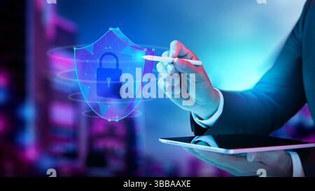 Businessman holding tablet while touching wireframe shield with padlock icon. Technology innovation on a virtual screen. Concept of Cybersecurity, dat Stock Photo