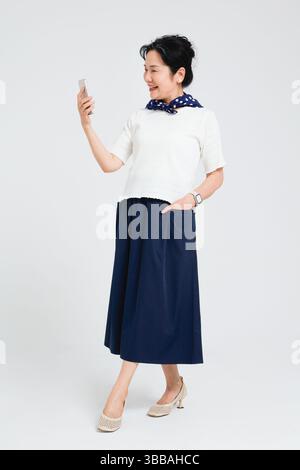Chinese elderly women using smartphones​ Stock Photo