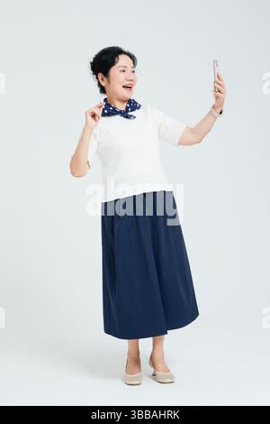 Chinese elderly women using smartphones​ Stock Photo