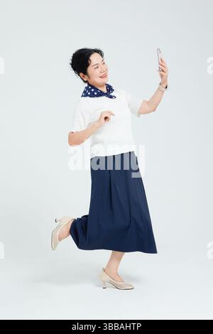 Chinese elderly women using smartphones​ Stock Photo