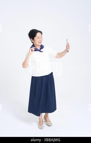 Chinese elderly women using smartphones​ Stock Photo