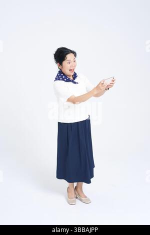 Chinese elderly women using smartphones​ Stock Photo