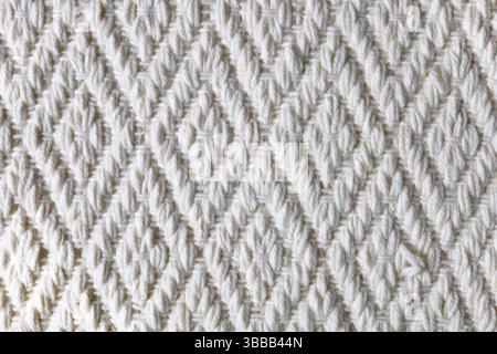 Close-Up of White Textured Crochet Fabric with Diamond Pattern – Soft Woolen Handcrafted Textile Background Stock Photo