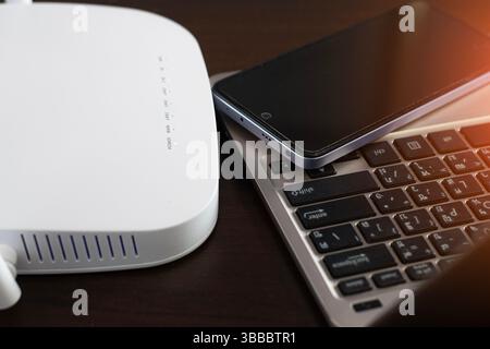 White router connects to Wi-Fi and 5G networks, connects to mobile phones and laptops. Stock Photo