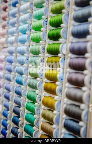 Colorful thread in spools on green background 2018 Stock Photo - Alamy