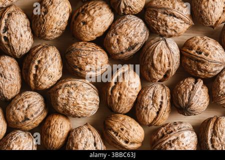 Top view of brown walnuts. Natural whole nuts background. Organic healthy snack. Dry shell texture closeup. Nutritious food ingredient. Autumn harvest Stock Photo