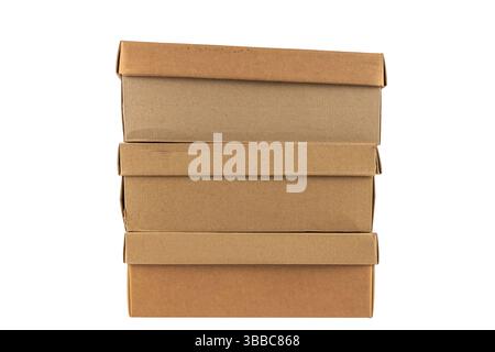 Three stacked brown cardboard shoe boxes stand upright on top of each other. The edges are slightly uneven, giving them a realistic, used appearance. Stock Photo