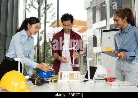 Innovative Engineering Team. Engineers collaborating on sustainable design with wind energy solutions. Stock Photo
