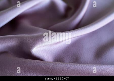 Soft lilac fabric with flowing folds and subtle elegant texture Stock Photo