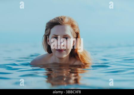 Portrait of beautiful young blond woman in the sea Stock Photo