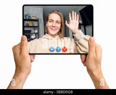 Isolated hands of woman holding digital tablet showing video call with woman waving on screen Stock Photo