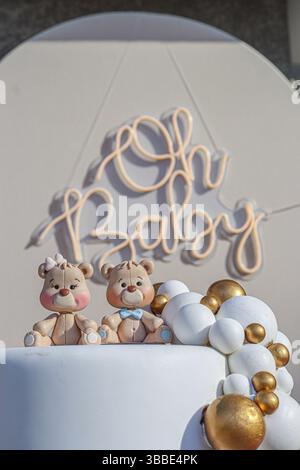 Gender Reveal Party Decoration with Two Bears on Top of a Non-Real Cake and a Sign Behind It That Says Oh Baby Stock Photo