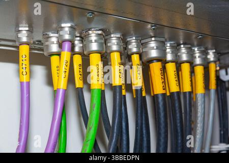 Several powerful electrical cables connected to a junction box. Stock Photo