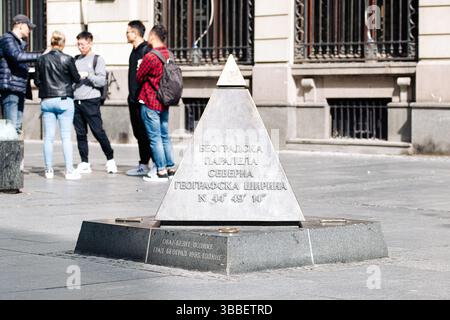 Belgrade, Serbia - September 20, 2019: Stone pyramid monument marking the 44th parallel north in Belgrade, serbia, with tourists standing nearby Stock Photo
