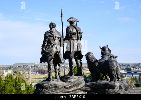 Great Falls, MT, USA - May 4, 2025; Rear view of Robert M. Scriver outdoor sculpture Explorers at the Portage overlooking modern day Great Falls Stock Photo
