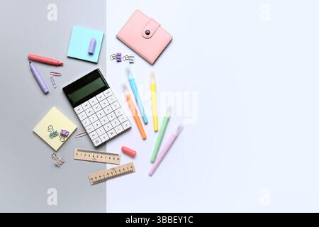 Modern calculator with different stationery on color background Stock Photo