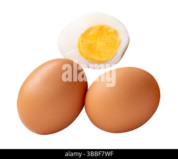 Top view of raw brown chicken eggs and cooked or boiled chicken egg with egg yolk in half is isolated on white background with clipping path. Stock Photo