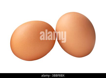 Two fresh brown chicken eggs in stack is isolated on white background with clipping path. Stock Photo