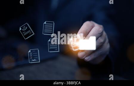 Document Management System concept. A man drags and drops files into DMS software to store, share, track and manage files or documents. Stock Photo