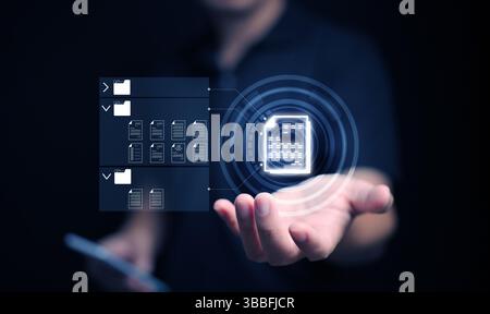 Document Management System concept. A man with his smartphone searches for a file stored in the DMS system for store, share, track and manage files or Stock Photo