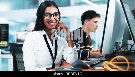 Happy woman, portrait or programmer on computer with glasses at office for future development or cybersecurity. Female person, developer or coder with Stock Photo