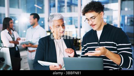 People, developer and mentor on laptop in office of programming, coding training and server update. Staff, manager and helping of app testing, IT Stock Photo