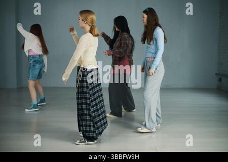 Teenagers Practicing Dance Moves in Modern Dance Studio Stock Photo