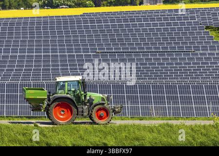 Agricultural land is used as a solar field. Tractor. Nellingen in the Swabian Alb. Nellingen, Baden-Wuerttemberg, Germany, Europe Stock Photo