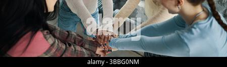 Group of People Joining Hands in Unity Gesture Stock Photo