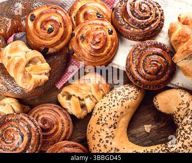 Breads,  buns, croissants. Various bakery ingredients on a wooden background. Breakfast food concept. Top view. Stock Photo