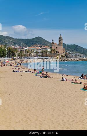 Sitges promenade with beach and church in Catalonia, Spain on a sunny day Stock Photo