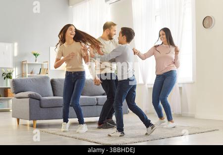 Happy family with children sharing moments of joy and laughter while having fun at home. Stock Photo