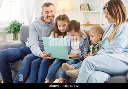 Happy family gathered in living room Stock Photo Alamy