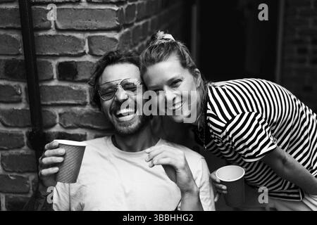 Portrait of happy male and female friends posing in back yard at party Stock Photo