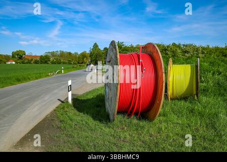 Bönen, North Rhine-Westphalia, Germany - Internet broadband expansion in the countryside, construction site for laying fibre optic cable, cable drum w Stock Photo