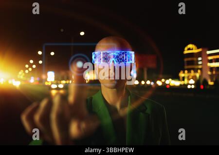 Woman in Futuristic neon VR eyeglasses interacting with smart ci Stock Photo