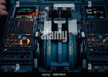 Throttle levers and control panel in commercial aircraft cockpit Stock Photo