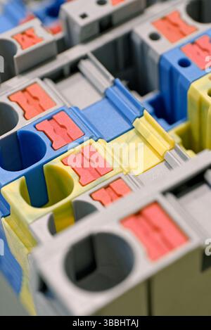 Variety of multi-colored plastic electrical installation terminals, close up shot, abstract background Stock Photo