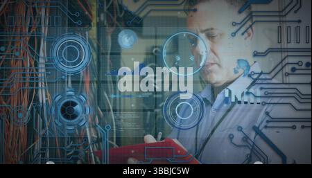Inspecting IT tech holding red clipboard, monitoring network cables at server room, copy space Stock Photo