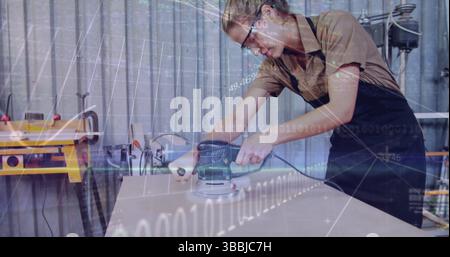 Sanding woman craftsperson using orbital sander on board in workshop, with binary graphics overlay Stock Photo