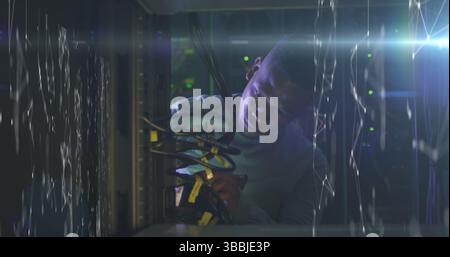 Image of connections over african american man working in server room Stock Photo