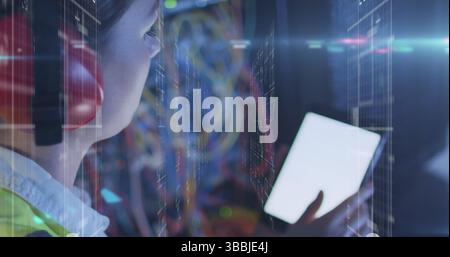 Image of lights over caucasian woman working on tablet with copy space in server room Stock Photo