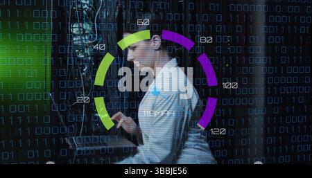 Image of data processing over caucasian woman using laptop server room Stock Photo