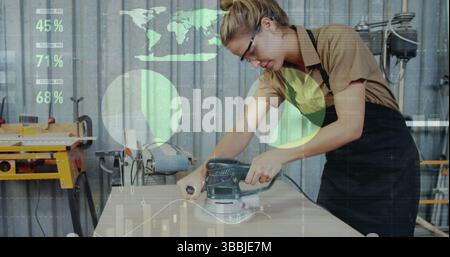 Image of world map and data processing over caucasian female carpenter working in workshop Stock Photo