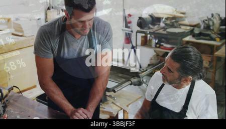 Image of financial graphs over caucasian men working in carpentry workshop Stock Photo