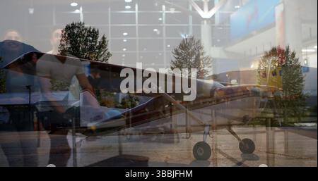 Image of diverse people waiting in airport over airplane Stock Photo