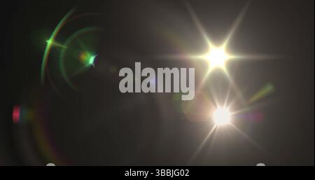 Image of glowing lights and spots over black background Stock Photo