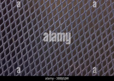 A black metal mesh with a black background. Stock Photo