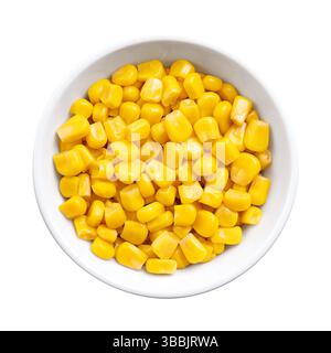 Canned corn, vegetable maize, whole sweet corn kernels in a white bowl. Variety of corn that is picked when in its milk state. Fully cooked kernels. Stock Photo