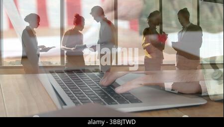 Image of diverse group of business people over person using laptop Stock Photo